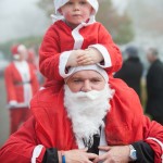 santa-run-child-on-father-christmas-shoulders